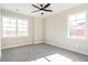 Spacious bedroom with many windows and neutral colored carpet at 164 Palm St, Holly Springs, GA 30188