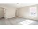 Sun-lit bedroom featuring neutral carpet and a walk-in closet at 164 Palm St, Holly Springs, GA 30188