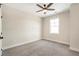 Bedroom with neutral carpet, white trim, one window, and fan at 164 Palm St, Holly Springs, GA 30188