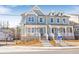 Charming townhome featuring a welcoming front porch at 164 Palm St, Holly Springs, GA 30188