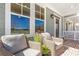 Inviting front porch with wicker seating, perfect for relaxing outdoors and brick floor at 164 Palm St, Holly Springs, GA 30188