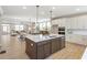 Open kitchen with a central island, stainless steel appliances, and wood flooring at 164 Palm St, Holly Springs, GA 30188