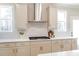Kitchen featuring white cabinets, stainless appliances, and subway tile backsplash at 164 Palm St, Holly Springs, GA 30188