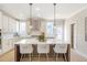 Modern kitchen featuring white cabinets, stainless appliances and a central island at 164 Palm St, Holly Springs, GA 30188