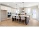 Kitchen featuring white cabinets, stainless appliances, and an island with bar seating at 164 Palm St, Holly Springs, GA 30188