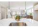 Kitchen island with stainless steel sink, quartz countertop, and white cabinets at 164 Palm St, Holly Springs, GA 30188