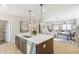 Modern kitchen island featuring white quartz countertop and stainless steel dishwasher at 164 Palm St, Holly Springs, GA 30188