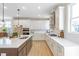 Bright kitchen with stainless appliances, white cabinetry, and quartz countertops at 164 Palm St, Holly Springs, GA 30188