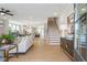 Spacious living room with hardwood floors, a staircase, and an open floor plan at 164 Palm St, Holly Springs, GA 30188