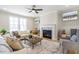 Cozy living room with fireplace, plush seating, and abundant natural light at 164 Palm St, Holly Springs, GA 30188