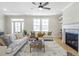 Elegant living room featuring fireplace, hardwood floors, and comfortable seating at 164 Palm St, Holly Springs, GA 30188