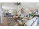 Bright living room with open floorplan to kitchen, fireplace and hardwood floors at 164 Palm St, Holly Springs, GA 30188