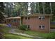 This house has a two-story brick exterior, complemented by lush greenery at 3798 King Henry Sw Rd, Atlanta, GA 30331