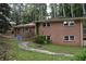 This house has a two-story brick exterior, complemented by lush greenery at 3798 King Henry Sw Rd, Atlanta, GA 30331