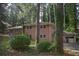 This house has a two-story brick exterior, surrounded by trees and greenery at 3798 King Henry Sw Rd, Atlanta, GA 30331