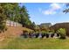 A beautiful backyard featuring grass, a garden with potted plants and a wooden fence for privacy at 4746 Highland Ave, Sugar Hill, GA 30518