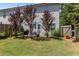 Fenced backyard features landscaping, a patio, and an umbrella table with chairs at 4746 Highland Ave, Sugar Hill, GA 30518