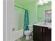 Bathroom featuring a shower/tub, dark wood vanity, and green walls at 4746 Highland Ave, Sugar Hill, GA 30518