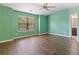 Bright bedroom featuring hardwood floors, a large window, and calming green walls at 4746 Highland Ave, Sugar Hill, GA 30518