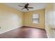 Cozy bedroom features hardwood floors, a ceiling fan, and a window at 4746 Highland Ave, Sugar Hill, GA 30518