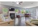 Bright and spacious living room with a fireplace, hardwood floors, and stylish furniture at 4746 Highland Ave, Sugar Hill, GA 30518