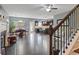 Open-concept living space featuring hardwood floors, stairs, fireplace, and a modern kitchen at 4746 Highland Ave, Sugar Hill, GA 30518