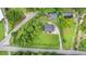 Birds eye view of the property, with a well-maintained lawn, mature trees, and a long driveway at 5599 Redan Cir, Stone Mountain, GA 30088
