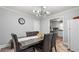 Bright dining room with modern lighting, seating for six and a refrigerator at 5599 Redan Cir, Stone Mountain, GA 30088