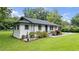 Well-kept home features fresh paint, tidy yard, and concrete sidewalk to front entrance at 5599 Redan Cir, Stone Mountain, GA 30088