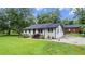 Lovely exterior with grassy lawn, tidy landscaping, and convenient rear parking pad at 5599 Redan Cir, Stone Mountain, GA 30088