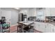 Kitchen features white cabinets, stainless steel appliances and a cozy dining island at 5599 Redan Cir, Stone Mountain, GA 30088