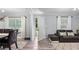 Comfortable living room features wood-look floors, neutral paint, and tons of natural light at 5599 Redan Cir, Stone Mountain, GA 30088