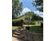 Charming single-story home with mature trees and front yard fenced-in with black iron at 661 Federal Se Ter, Atlanta, GA 30315