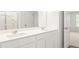 Bathroom features a double vanity, large mirror, and a view into the bedroom through the open door at 7254 Deering Court Lot 177, Douglasville, GA 30134