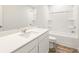 Bright bathroom featuring wood-look floors, white cabinets and white tub with shower at 7254 Deering Court Lot 177, Douglasville, GA 30134