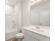 Bright bathroom features wood-look floors, white cabinets and white tub with shower at 7254 Deering Court Lot 177, Douglasville, GA 30134