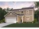 Charming two-story home featuring a manicured lawn, attached garage, and a welcoming front entrance with a covered porch at 7254 Deering Court Lot 177, Douglasville, GA 30134