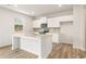 Bright kitchen features white cabinets, stainless appliances, granite countertops, and wood flooring at 7254 Deering Court Lot 177, Douglasville, GA 30134