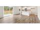 Open concept kitchen and dining room with stainless appliances and a view of the landscaped back yard at 7254 Deering Court Lot 177, Douglasville, GA 30134