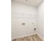 Bright laundry room features wood-look floors and wire shelving above the washer and dryer hookups at 7254 Deering Court Lot 177, Douglasville, GA 30134