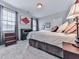Comfortable bedroom featuring neutral walls, carpet, stylish décor and plenty of natural light at 1076 Pinyan Ln, Canton, GA 30115