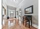 Light-filled foyer with hardwood floors, a decorative rug, and a classic entry table at 1076 Pinyan Ln, Canton, GA 30115