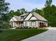 Charming exterior with a well-manicured lawn, stone accents, and a welcoming front porch at 1076 Pinyan Ln, Canton, GA 30115