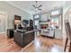 Comfortable living room with hardwood floors, a stone fireplace, and ample natural light at 1076 Pinyan Ln, Canton, GA 30115