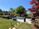 Inviting backyard pool area featuring comfortable lounge seating and mature landscaping at 1076 Pinyan Ln, Canton, GA 30115