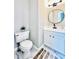 Powder room with gray walls, white vanity, and patterned marble flooring at 430 Thornbush Trce, Lawrenceville, GA 30046