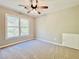 Bedroom features plush carpet, large window for natural light, and ceiling fan at 430 Thornbush Trce, Lawrenceville, GA 30046