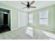 Bedroom featuring three windows, a ceiling fan, and double door closet at 430 Thornbush Trce, Lawrenceville, GA 30046