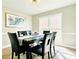 Elegant dining area with modern lighting, hardwood floors, and serene natural light at 430 Thornbush Trce, Lawrenceville, GA 30046