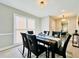 Formal dining room with modern lighting, hardwood floors, and seamless access to living spaces at 430 Thornbush Trce, Lawrenceville, GA 30046